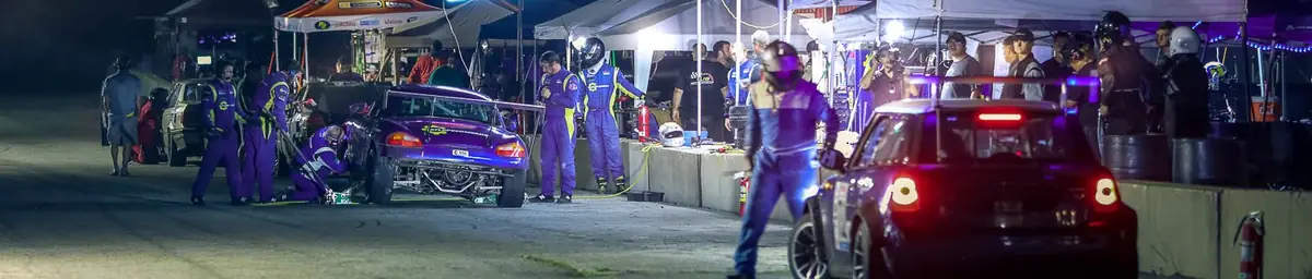 Night-time pit stops under the lights at a ChampCar event